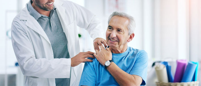 a doctor with his hands on patients shoulder